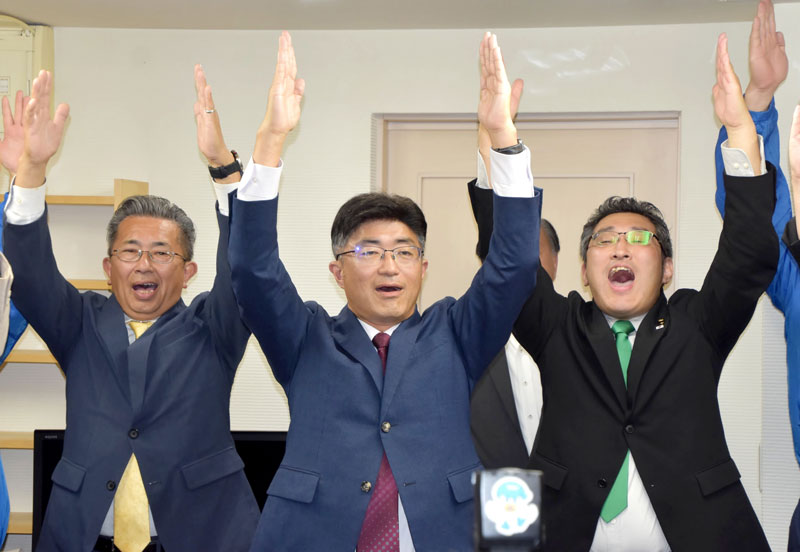 支援者らと万歳三唱して当選を喜ぶ松戸氏（中央）＝１日深夜、松戸市