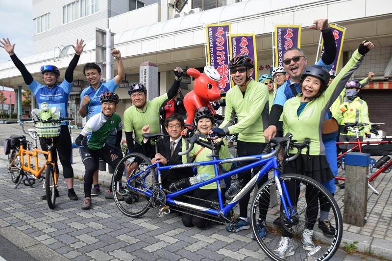 自転車道起点モニュメント前で出発前に記念撮影する参加メンバーら＝２９日、銚子市
