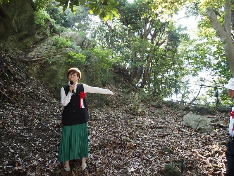 敵を防ぐ二重堀切に立ち、遊歩道を案内する山城ガールむつみさん＝富津市
