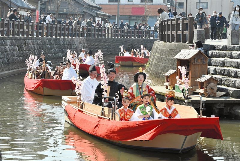 ひな人形の衣装をまとった参加者が舟で佐原の町並みを巡る「さわら雛舟春祭り」。観光客は春のひとときを楽しんだ＝２日、香取市
