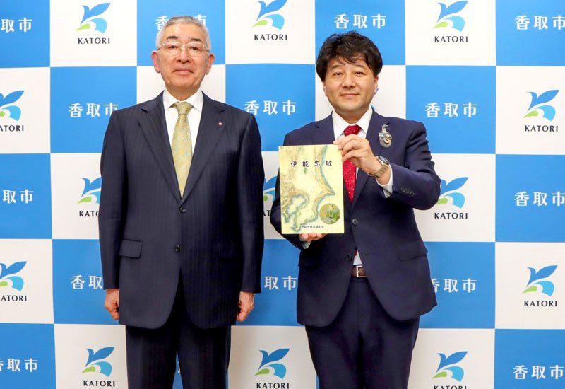 郷土の偉人、伊能忠敬の資料本を伊藤市長（右）に手渡した坂本会長＝香取市役所（市提供）