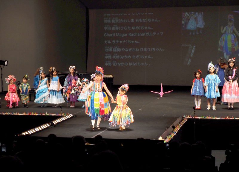 折り鶴を使った衣装を着て平和を願うメッセージを発信する子どもたち＝君津市