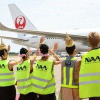 タイ人ダンサーらが出発前の航空機を見送った＝成田空港