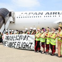タイ人ダンサーや日本航空スタッフが乗客を出迎えた＝成田空港