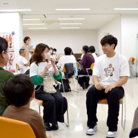 患者たちと笑顔で語り合う原選手（右）