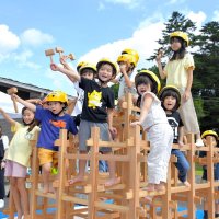 協力して作り上げたジャングルジムにうれしそうに上る子どもたち
